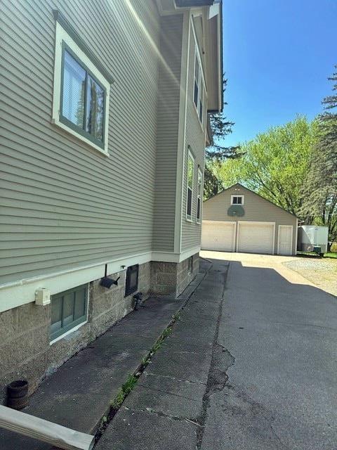 110 Hewett St, Neillsville, WI 54456 - view of side of home with a garage and an outbuilding