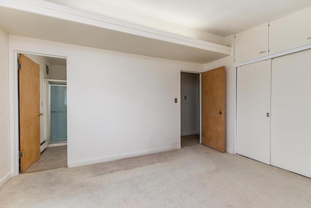 30 Elmer St, Platteville, WI 53818 - unfurnished bedroom with light carpet, a baseboard radiator, a closet, connected bathroom, and baseboards
