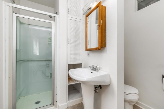 30 Elmer St, Platteville, WI 53818 - full bathroom featuring a shower stall, toilet, and baseboards