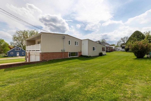 30 Elmer St, Platteville, WI 53818 - view of side of home featuring a garage, a yard, brick siding, and a balcony