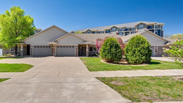 2149 Abbey Rd Unit 2147-2145, Onalaska, WI 54650 - view of front of home with a garage, a front lawn, driveway, and stone siding