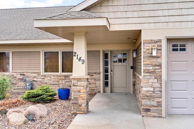 2149 Abbey Rd Unit 2147-2145, Onalaska, WI 54650 - view of exterior entry featuring stone siding and roof with shingles