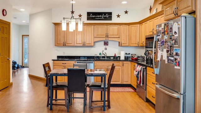 2149 Abbey Rd Unit 2147-2145, Onalaska, WI 54650 - kitchen featuring appliances with stainless steel finishes, a sink, recessed lighting, decorative light fixtures, and a kitchen bar