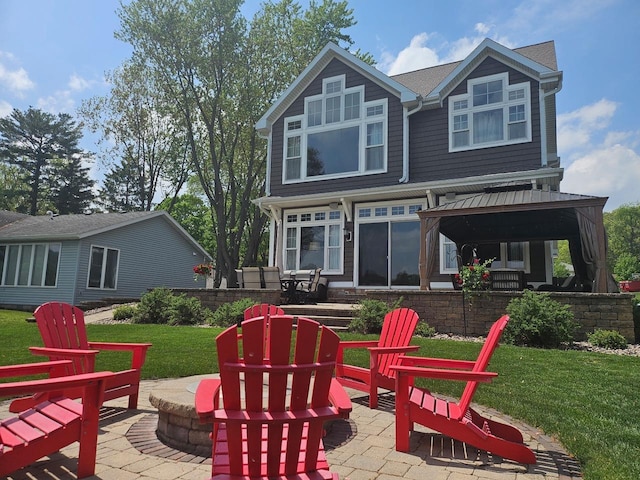 W11601 Demynck Rd, Lodi, WI 53555 - back of house featuring a patio, a yard, a gazebo, and an outdoor fire pit