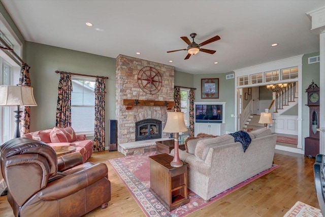 W11601 Demynck Rd, Lodi, WI 53555 - living area featuring stairs, a ceiling fan, a stone fireplace, wood finished floors, and recessed lighting