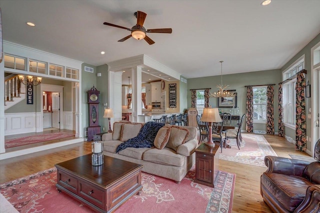 W11601 Demynck Rd, Lodi, WI 53555 - living room with a chandelier, wood finished floors, a ceiling fan, wainscoting, and recessed lighting
