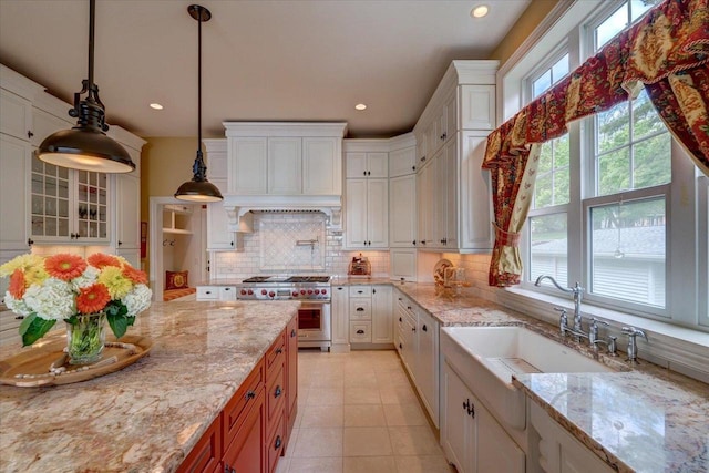 W11601 Demynck Rd, Lodi, WI 53555 - kitchen featuring stainless steel range, a sink, tasteful backsplash, light stone counters, and recessed lighting