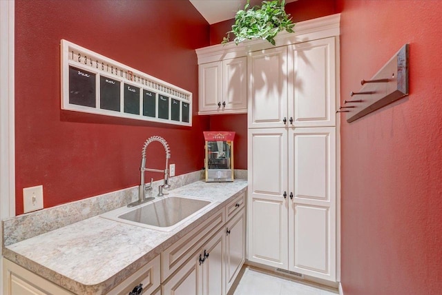 W11601 Demynck Rd, Lodi, WI 53555 - kitchen with a sink, light countertops, white cabinets, and light tile patterned floors