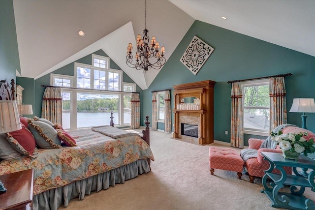 W11601 Demynck Rd, Lodi, WI 53555 - bedroom with high vaulted ceiling, a chandelier, carpet flooring, a fireplace with flush hearth, and a water view