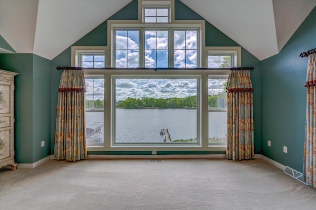 W11601 Demynck Rd, Lodi, WI 53555 - unfurnished living room featuring carpet floors, vaulted ceiling, a water view, and baseboards