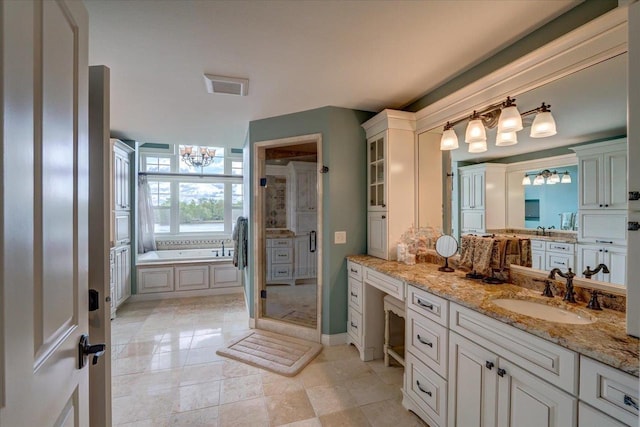 W11601 Demynck Rd, Lodi, WI 53555 - bathroom featuring a chandelier, a garden tub, vanity, a shower stall, and baseboards