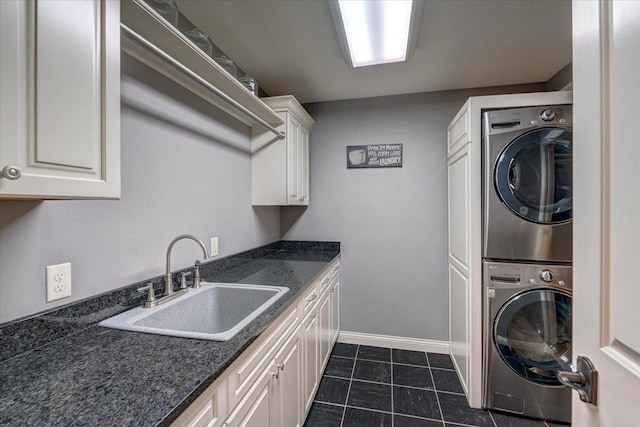W11601 Demynck Rd, Lodi, WI 53555 - washroom with estacked washer and dryer, cabinet space, baseboards, and dark tile patterned floors
