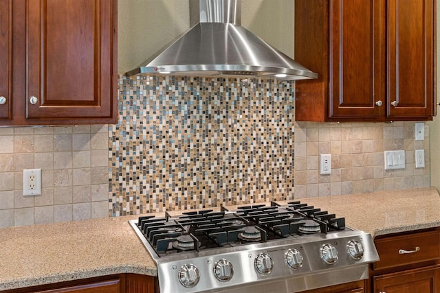 6056 Sharonwood Ln, Stevens Point, WI 54482 - kitchen featuring wall chimney exhaust hood, stovetop, tasteful backsplash, and light stone counters
