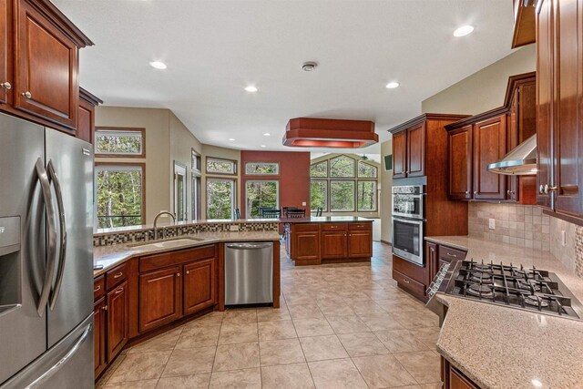 6056 Sharonwood Ln, Stevens Point, WI 54482 - kitchen with stainless steel appliances, a sink, under cabinet range hood, healthy amount of natural light, and recessed lighting
