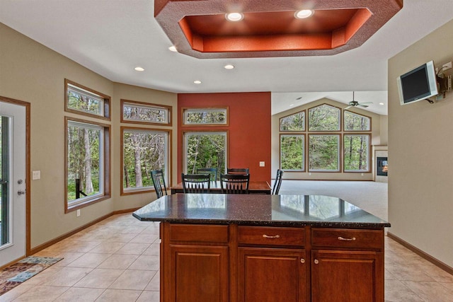 6056 Sharonwood Ln, Stevens Point, WI 54482 - kitchen with recessed lighting, light tile patterned floors, baseboards, dark stone countertops, and a raised ceiling