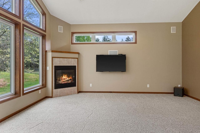 6056 Sharonwood Ln, Stevens Point, WI 54482 - unfurnished living room featuring carpet flooring, plenty of natural light, a fireplace, and baseboards