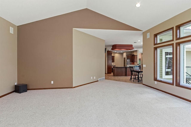 6056 Sharonwood Ln, Stevens Point, WI 54482 - carpeted living room featuring vaulted ceiling, baseboards, and recessed lighting