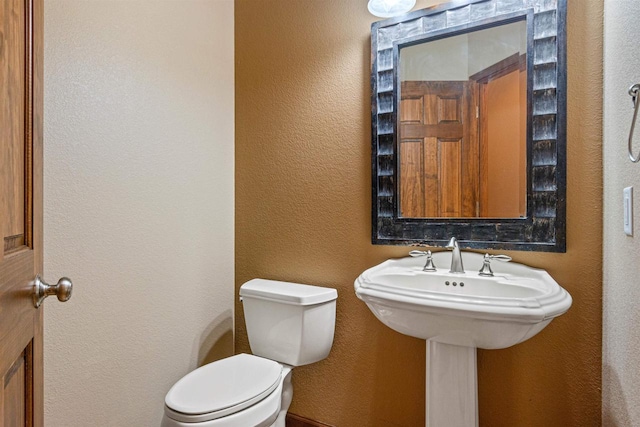 6056 Sharonwood Ln, Stevens Point, WI 54482 - half bathroom featuring toilet and a textured wall