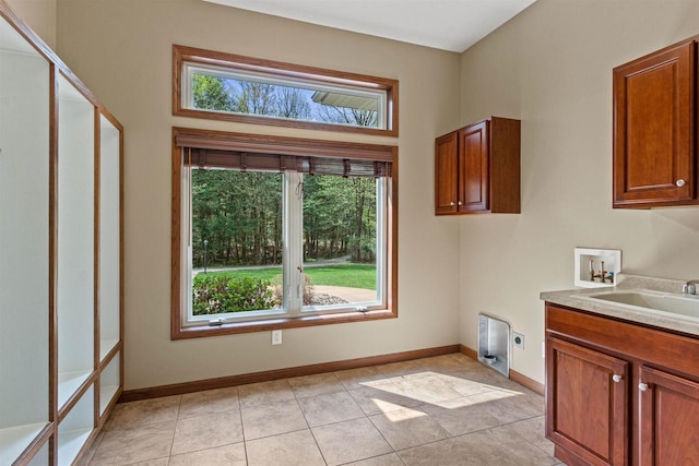 6056 Sharonwood Ln, Stevens Point, WI 54482 - clothes washing area with hookup for an electric dryer, hookup for a washing machine, healthy amount of natural light, and cabinet space