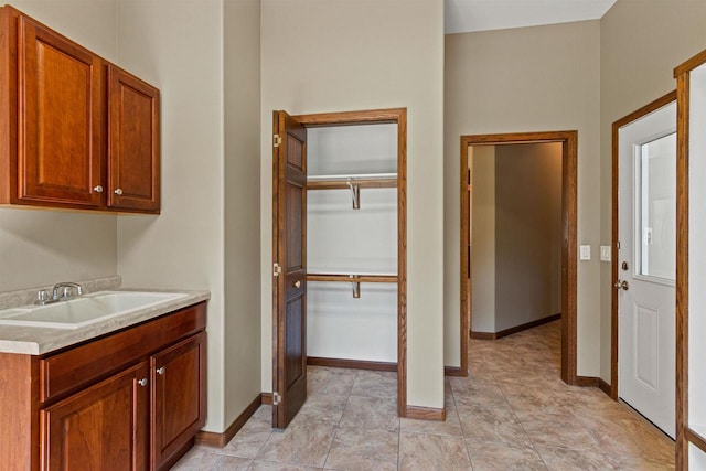 6056 Sharonwood Ln, Stevens Point, WI 54482 - laundry room featuring a sink and baseboards