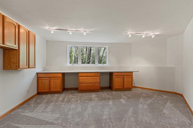 6056 Sharonwood Ln, Stevens Point, WI 54482 - unfurnished office with track lighting, built in desk, light colored carpet, and baseboards