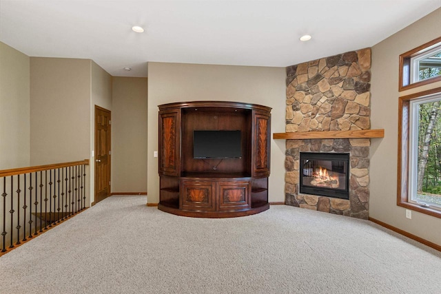 6056 Sharonwood Ln, Stevens Point, WI 54482 - unfurnished living room with carpet floors, a stone fireplace, baseboards, and recessed lighting
