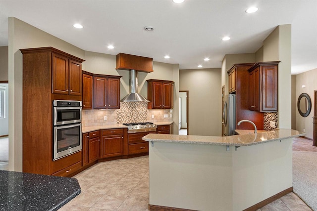 6056 Sharonwood Ln, Stevens Point, WI 54482 - kitchen featuring appliances with stainless steel finishes, a peninsula, wall chimney range hood, decorative backsplash, and recessed lighting