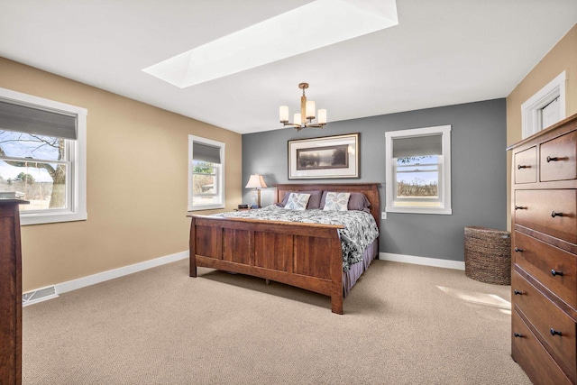 N8608 Strat Rd, Iola, WI 54945 - carpeted bedroom featuring a skylight, a chandelier, multiple windows, and baseboards