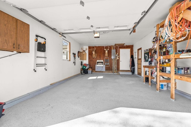 N8608 Strat Rd, Iola, WI 54945 - garage with a garage door opener, heating unit, and electric panel
