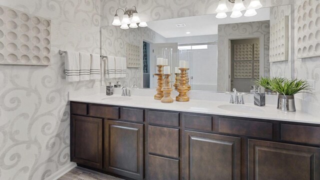 4011 Banbury St, Windsor, WI 53598 - full bath featuring wallpapered walls, double vanity, and wood finished floors