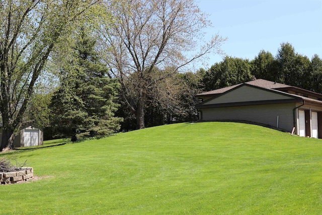 N422 Dons Dr, Appleton, WI 54915 - view of green lawn featuring an outdoor fire pit, a shed, an outbuilding, and a garage