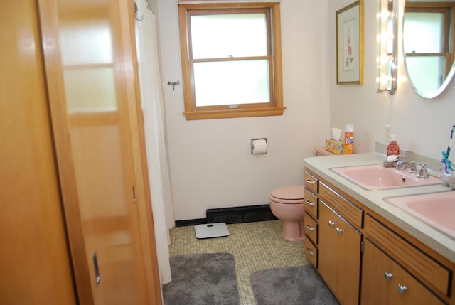 3207 County Rd W, Port Washington, WI 53074 - bathroom with toilet, double vanity, tile patterned floors, and baseboards