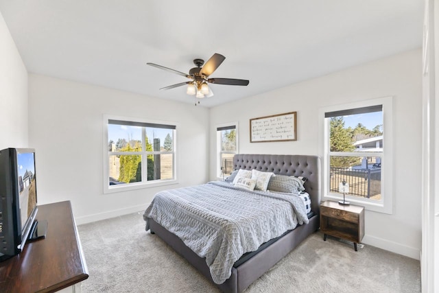 bedroom with baseboards, light carpet, and ceiling fan
