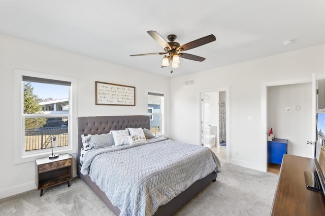 bedroom featuring light carpet, multiple windows, baseboards, and ceiling fan
