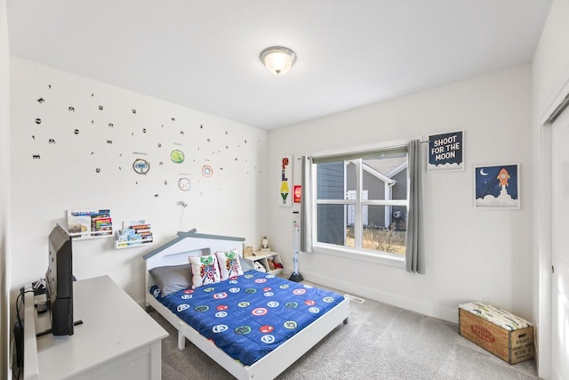 carpeted bedroom featuring baseboards