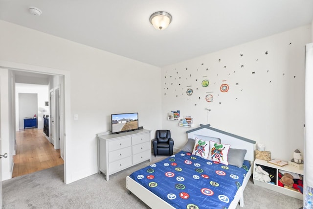 bedroom featuring light carpet