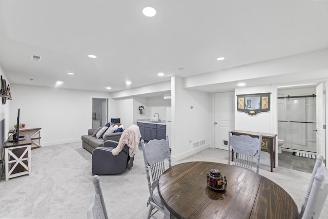 dining area with light colored carpet, recessed lighting, baseboards, and bar area
