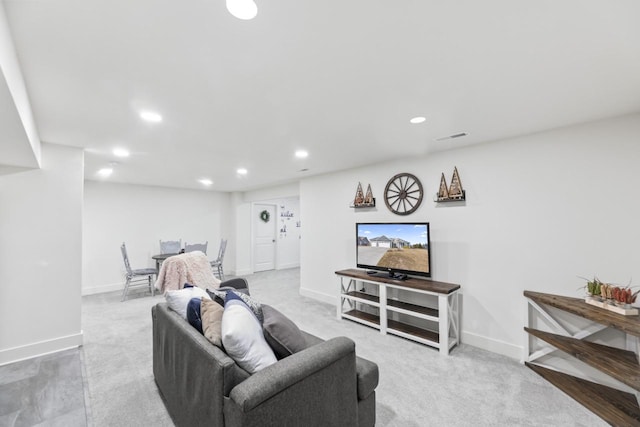 carpeted living area featuring recessed lighting and baseboards