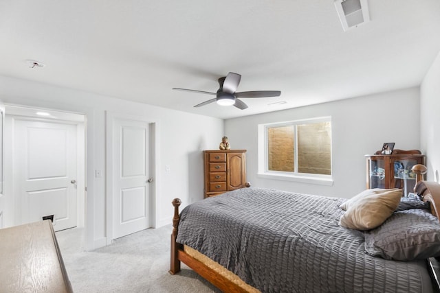 bedroom with light colored carpet and a ceiling fan
