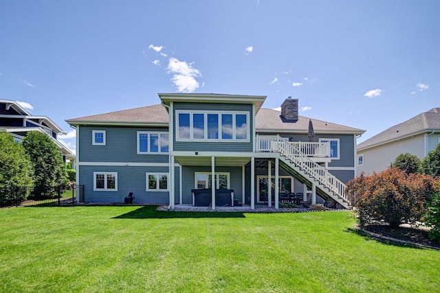 1115 Ireland Dr, Waunakee, WI 53597 - rear view of property with stairway, a chimney, and a wooden deck