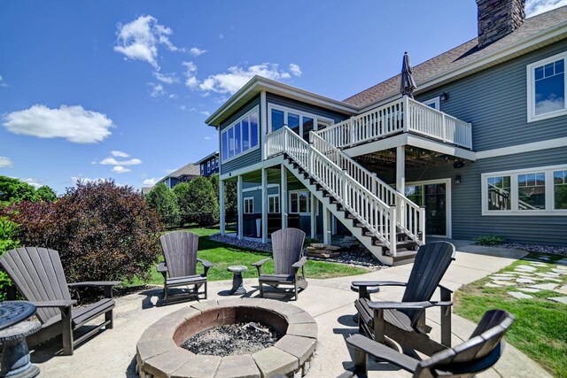 1115 Ireland Dr, Waunakee, WI 53597 - view of patio / terrace featuring a fire pit, stairway, and a wooden deck