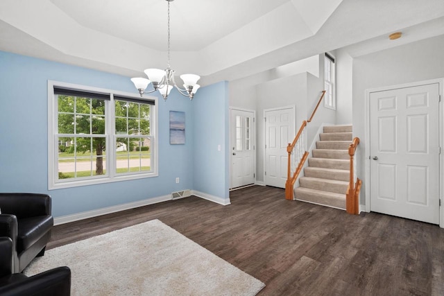 416 Rimrock Rd, Janesville, WI 53548 - unfurnished room with stairway, dark wood-style flooring, a chandelier, and baseboards