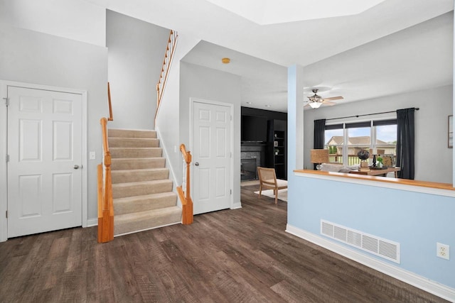 416 Rimrock Rd, Janesville, WI 53548 - living area featuring a glass covered fireplace, wood finished floors, stairs, baseboards, and ceiling fan