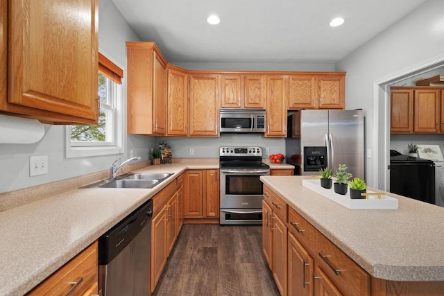 416 Rimrock Rd, Janesville, WI 53548 - kitchen featuring stainless steel appliances, washer and dryer, a sink, dark wood-style flooring, and recessed lighting