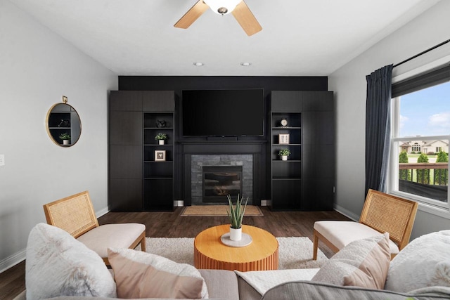 416 Rimrock Rd, Janesville, WI 53548 - living area with baseboards, a fireplace, a ceiling fan, and dark wood-style floors