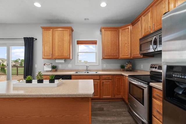 416 Rimrock Rd, Janesville, WI 53548 - kitchen featuring stainless steel appliances, a sink, light countertops, dark wood-type flooring, and recessed lighting