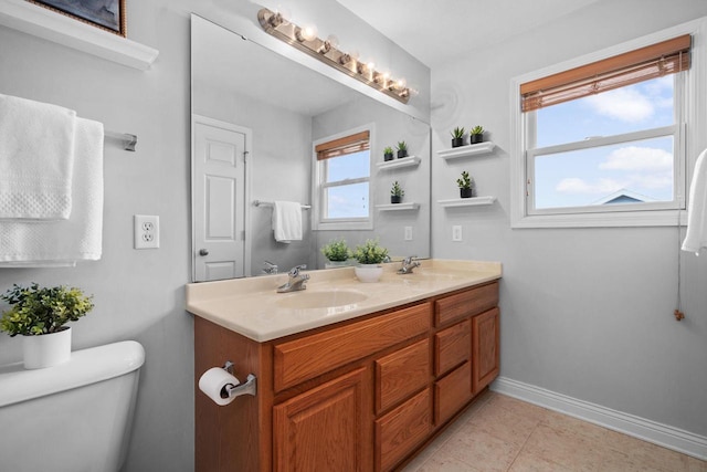 416 Rimrock Rd, Janesville, WI 53548 - full bathroom featuring baseboards, double vanity, and toilet
