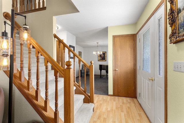2425 Sandstone Ct, Oshkosh, WI 54904 - entrance foyer featuring light wood finished floors, a chandelier, and stairway