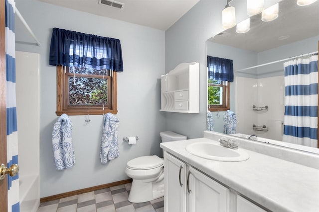 2425 Sandstone Ct, Oshkosh, WI 54904 - full bathroom with tile patterned floors, toilet, vanity, and baseboards