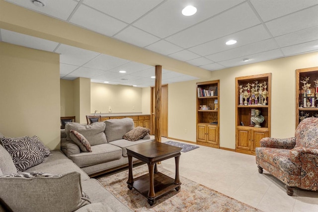 2425 Sandstone Ct, Oshkosh, WI 54904 - living room featuring a drop ceiling, built in shelves, tile patterned flooring, recessed lighting, and bar